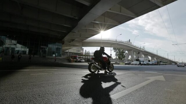 Motorcyclist stops at red light in Bucharest Romania