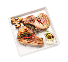 Plate with tasty steaks and spices on white background