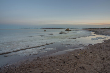 Rocky coast and sea. Finland, Scandinavian nature. Evening seascape, early spring, Long exposure.