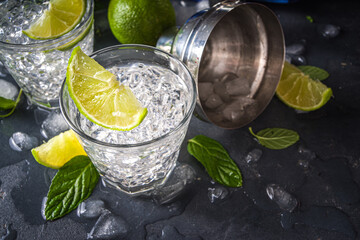 Summer paloma cocktail, vodka lime, mojito or gin tonic with lime wedge and crushed ice in rocks,...