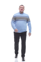 in full growth. casual man in a knitted sweater walking forward