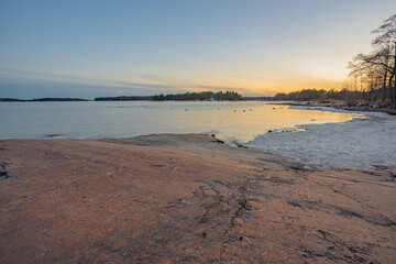 Rocky coast and sea. Finland, Scandinavian nature. Evening seascape, early spring, Long exposure.