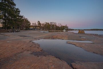 Rocky coast and sea. Finland, Scandinavian nature. Evening seascape, early spring, Long exposure.