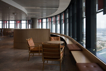 Office space brown leather chairs bench window timber modern fitout commercial real estate interior tower view