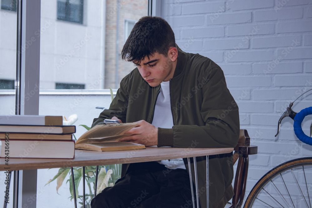 Sticker teenage boy studying at home