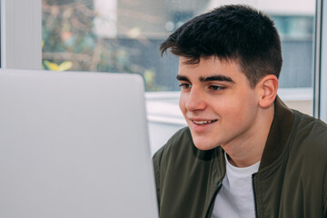 portrait of young teenager looking at computer