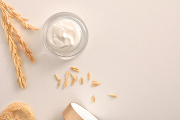 Background with oat moisturizer cream with spikes on white table