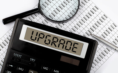 Calculator with text UPGRADE on the chart. Business, finance conceptual.