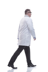 in full growth. confident male doctor striding forward