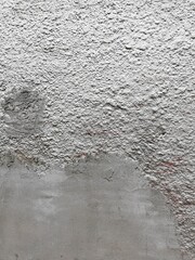Cement two-texture wall, smooth and loose, painted with silver paint.