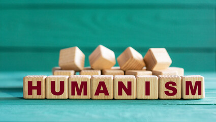 HUMANISM - word on wooden cubes on a green background with lavender