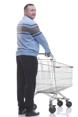 rear view. casual man with a cart standing in front of a white screen