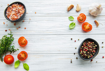 Tomato, basil and pepper with garlic on white wooden background