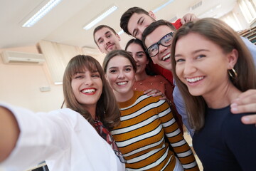 Obraz premium Group of multiethnic teenagers taking a selfie in school