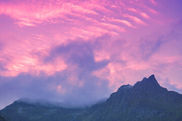 Silhouette of mountains against the purple sunset sky. Norway nature