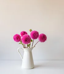 Deurstickers Bright pink dahlias in white jug on table against wall (selective focus) © Natalie Board