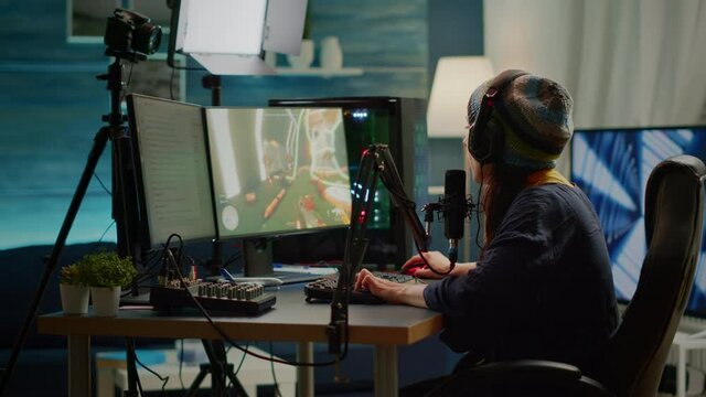Woman streamer checking sound using professional mixer for streaming video games in gaming home studio. Pro gamer playing first person shooter video games talking with team mates on open chat