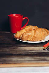 croissants plates wooden table drink mug breakfast dessert