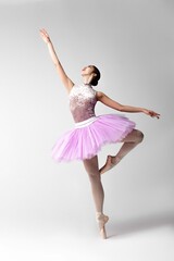 Naklejka premium Beautiful ballerina in pink tutu dancing