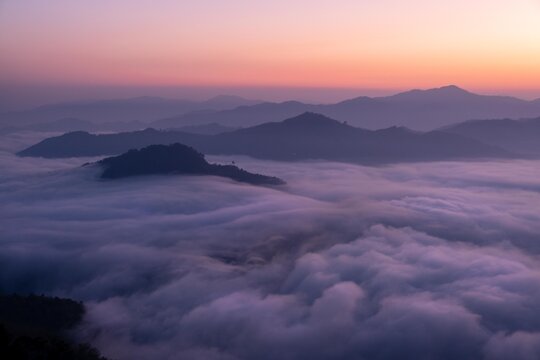 A sea of mist at the sunrise during twilight at the Iyaweng Betong Skywalk shining golden light.