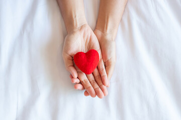 Woman holding Red heart shape on white background. Healthcare, life Insurance, donation, health and...