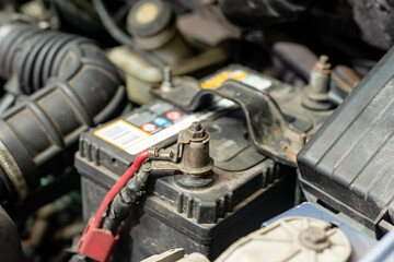 There is a connected battery under the hood of the car.