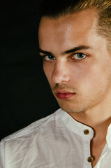 Portrait of a young attractive guy with blue eyes.