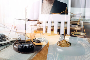Business and lawyers discussing contract papers with brass scale on desk in office. Law, legal services, advice, justice and law concept picture with film grain effect