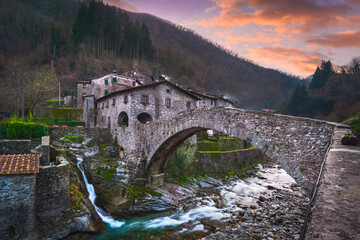 Fabbriche di Vallico ancient village and old bridge over the creek. Apuane park. Garfagnana, Tuscany, Italy. - obrazy, fototapety, plakaty
