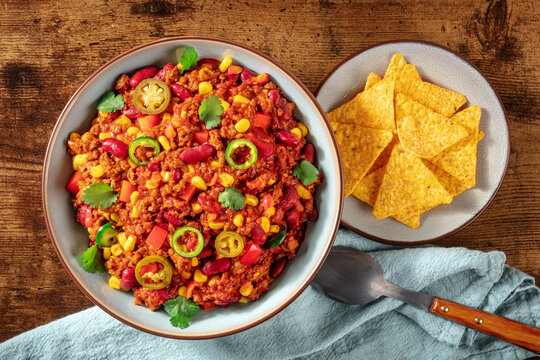 Chili Con Carne, Spicy Stew With Beans And Meat, Shot From Above With Nachos