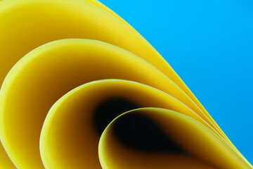 Abstract yellow and blue colored background with curved lines and shapes