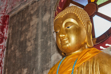 Phayao, Thailand - Dec 20, 2020: Zoom View Front Left Gold Buddha Statue in Chinese Temple at Wat Analayo Temple