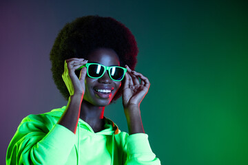 Photo of pretty disco 90s style lady look empty space wear sunglass sweatshirt isolated gradient green neon background