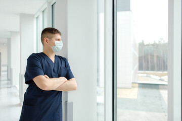Portrait of tired exhausted nurse or doctor at the hospital. COVID-19, Coronavirus pandemic. High...