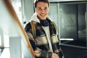 Young man smiling at camera at college staircase