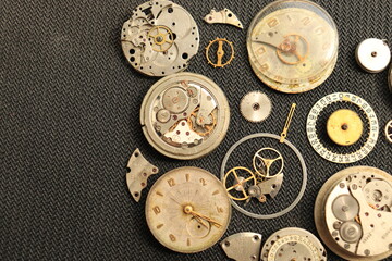 Clockwork gear wheels, close up view. Industry background. A few old watches