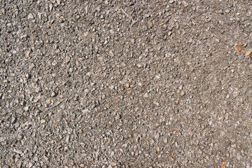 Wide Angle Gravel or Pebble on Asphalt Road Texture Background in Natural Light