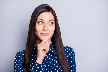 Portrait of optimistic brunette girl look empty space hand chin wear blue blouse isolated on grey color background © deagreez