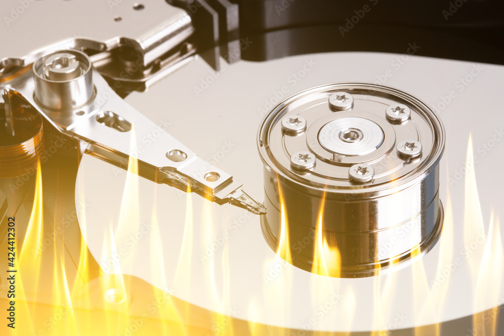 Poster a hard disk with flame tongues. burnt disk in the computer. data loss