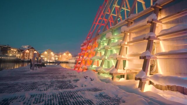 Modern Floating Sauna With Colorful Lights At Tromso Harbour In Norway During Winter. - Dolly Shot