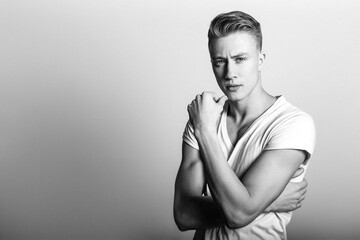 Fototapeta na wymiar Fashion man model posing on white background