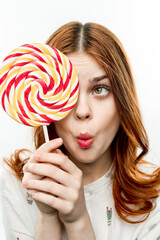 emotional woman with round multicolored lollipop near face enjoyment joy