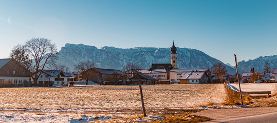 Beautiful winter landscape with a church and the famous Untersberg summit in the background on a sunny morning at Feldkirchen near Bad Reichenhall, Bavaria, Germany
