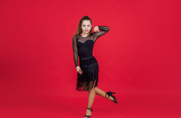 teen girl ballroom dancer. kid dancing in black dress. child in dance pose. professional slowfox and quickstep. waltz and tango. dancewear fashion clothes. dancing school