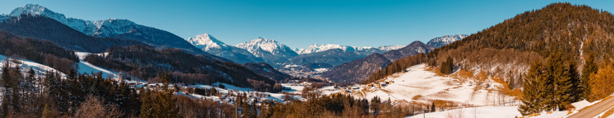 High res stitched panorama of a beautiful winter landscape on a sunny morning with the famous Watzmann, Hochkalter and Reiteralm summits in the background near Berchtesgaden, Bavaria, Germany
