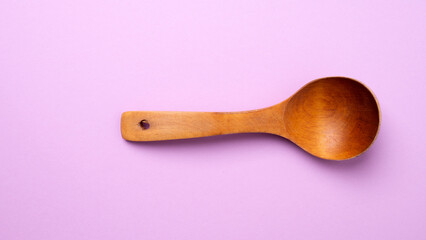wooden spoon for food on a colored background. old vintage spoon