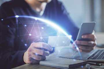 Double exposure of man's hands holding and using a phone and social network theme drawing.