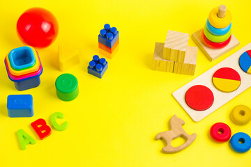 Plastic and wooden colorful toys blocks, letters and bricks. Activity for kids in day care and kindergarten