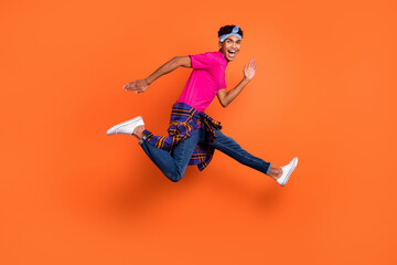 Full length body size side profile photo of guy jumping up running fast on sale isolated vivid orange color background