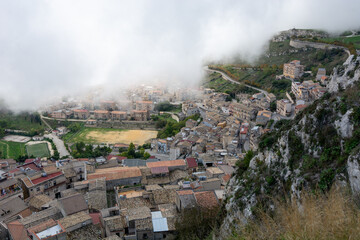 View on the mountain village Caltabellotta in Sicily at daylight with low hanging clouds